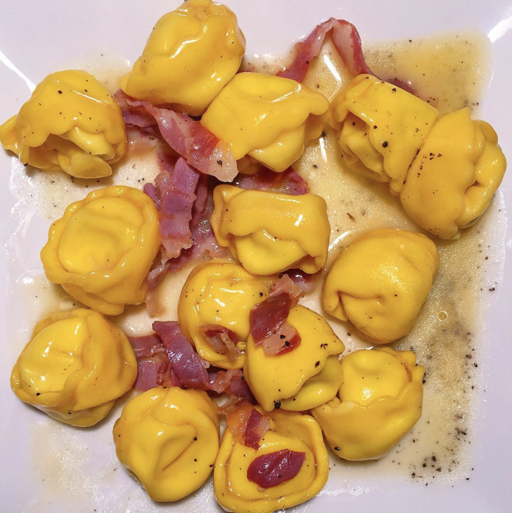 a plate of truffled ricotta cappelletti with prosciutto and butter from osteria morini in soho nyc
