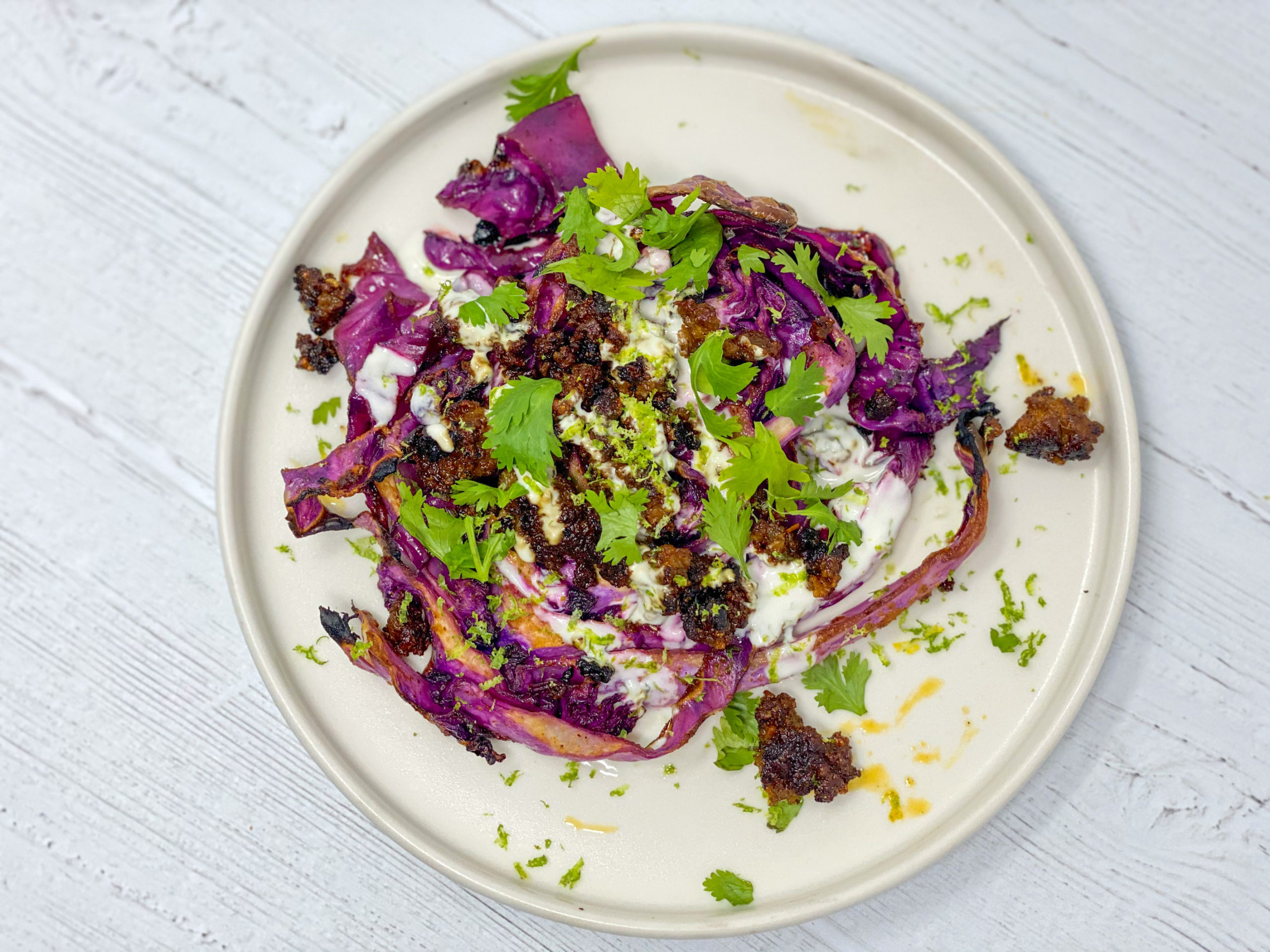 Charred cabbage with chorizo and lime crema