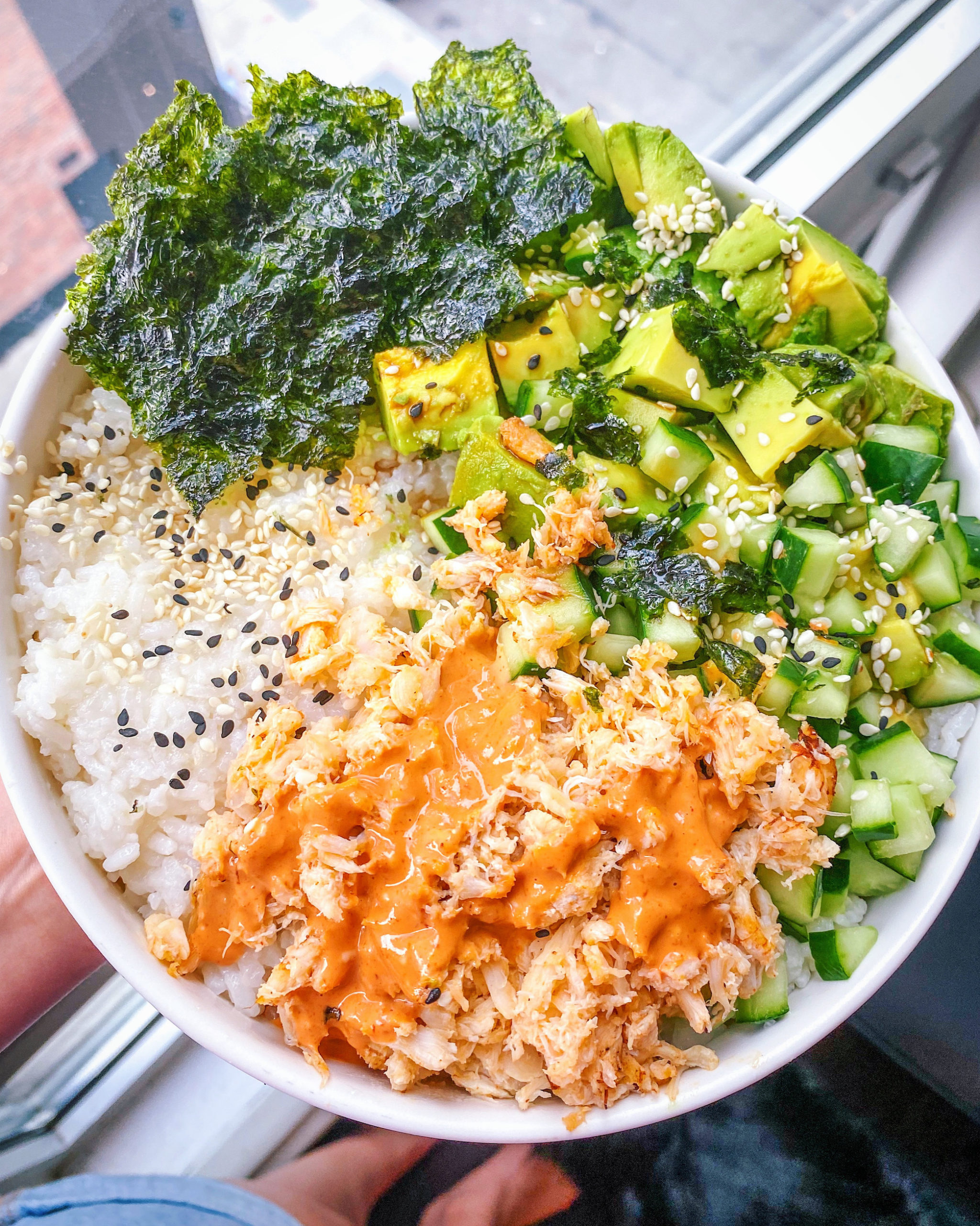 California roll poke bowl with avocado, cucumber, spicy mayo and seaweed