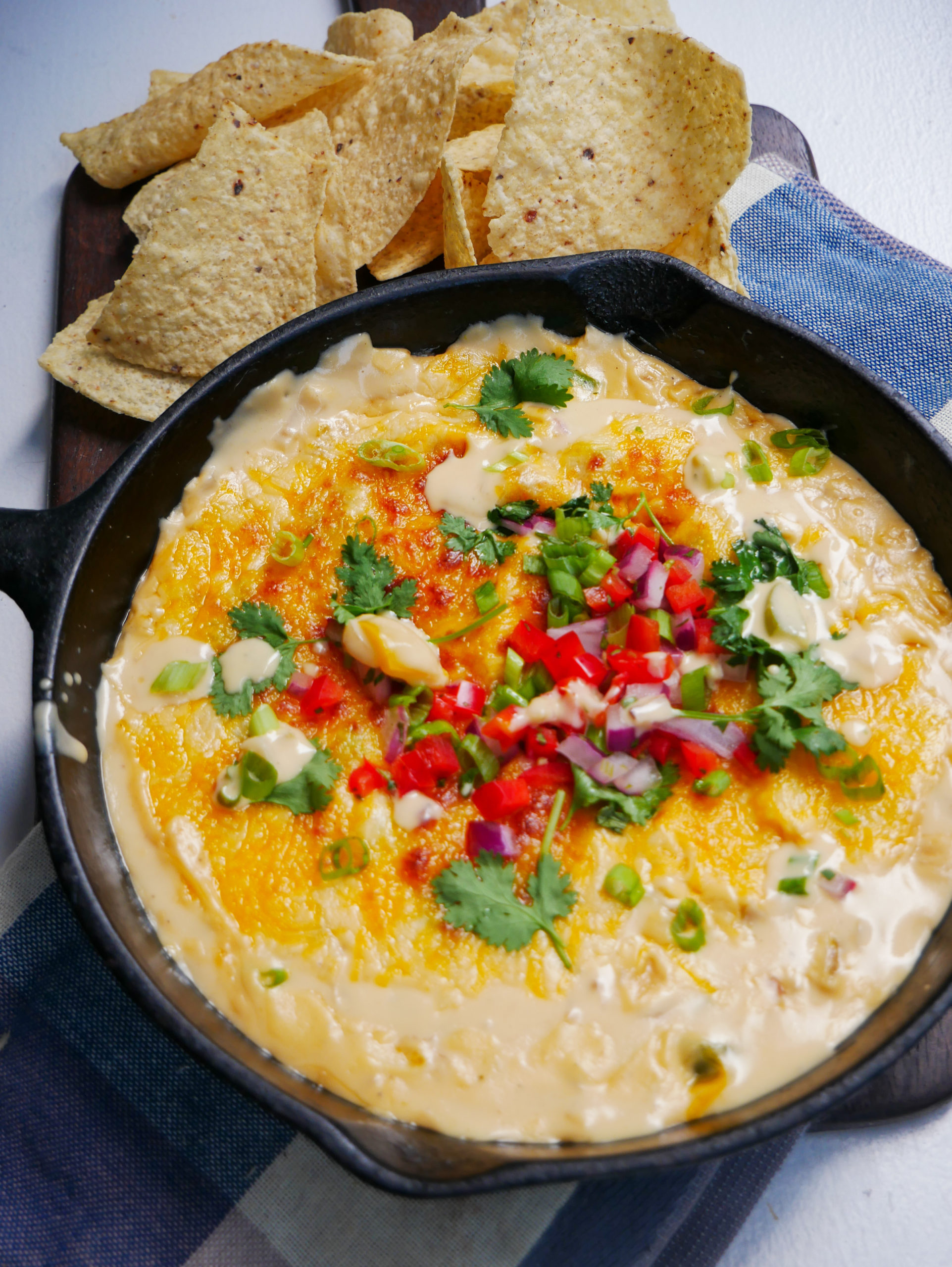 extra creamy easy queso dip in a cast iron skillet