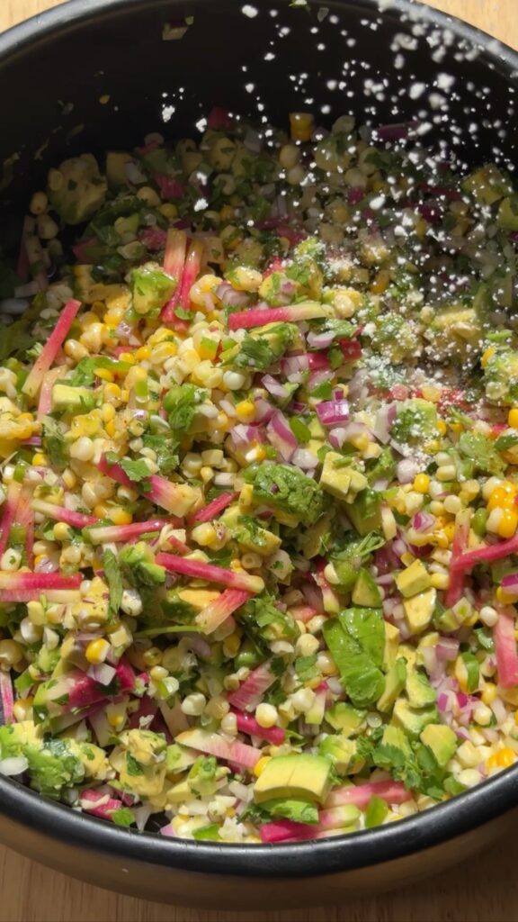 Mexican street corn salad with grilled sweet corn, radishes, avocado, cotija cheese, cilantro, and chipotle-lime vinaigrette. Easy summer side dish inspired by elote, perfect with grilled chicken, steak, shrimp, carnitas, or lobster.