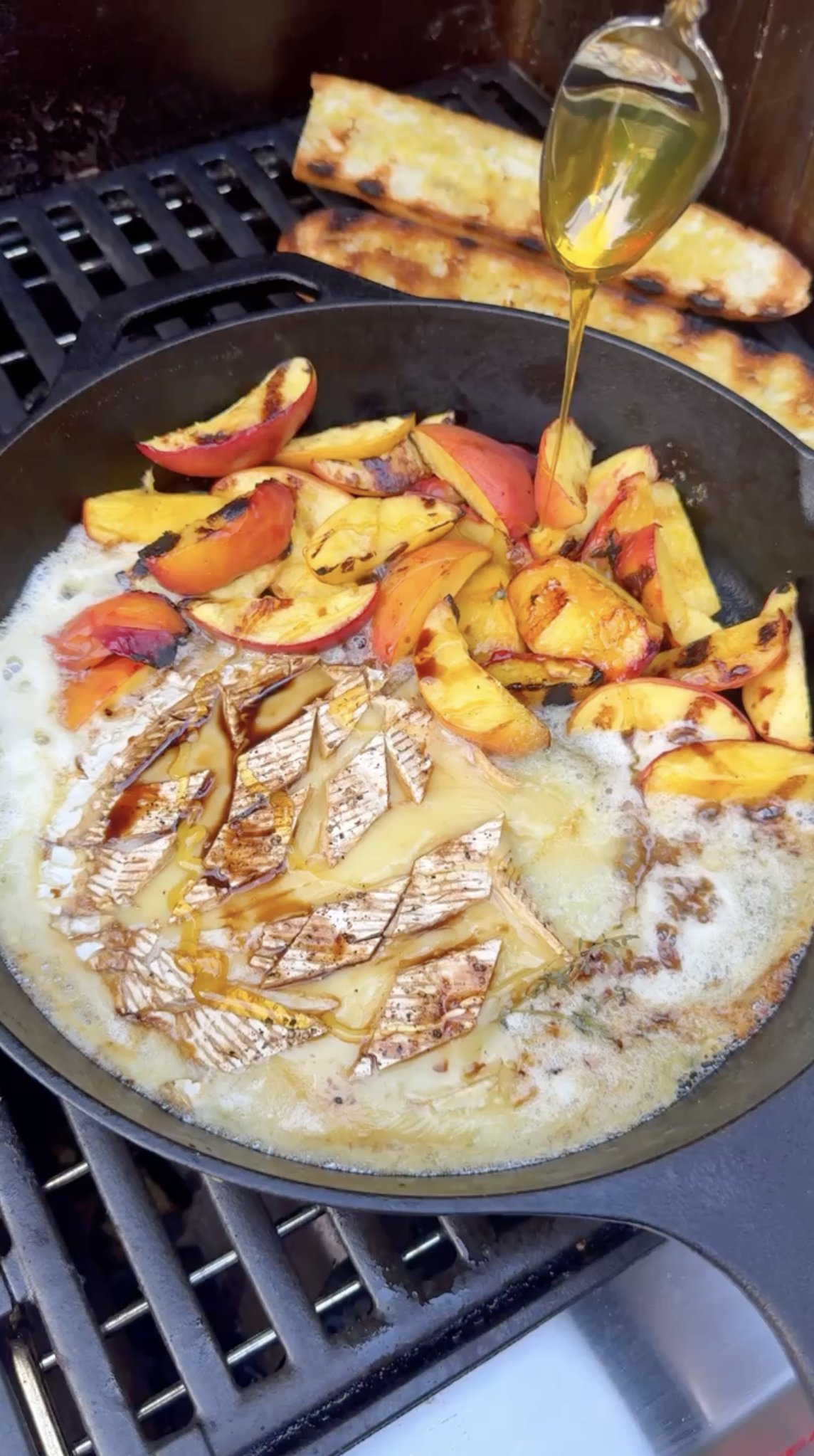 Warm baked brie topped with balsamic peaches and fresh thyme