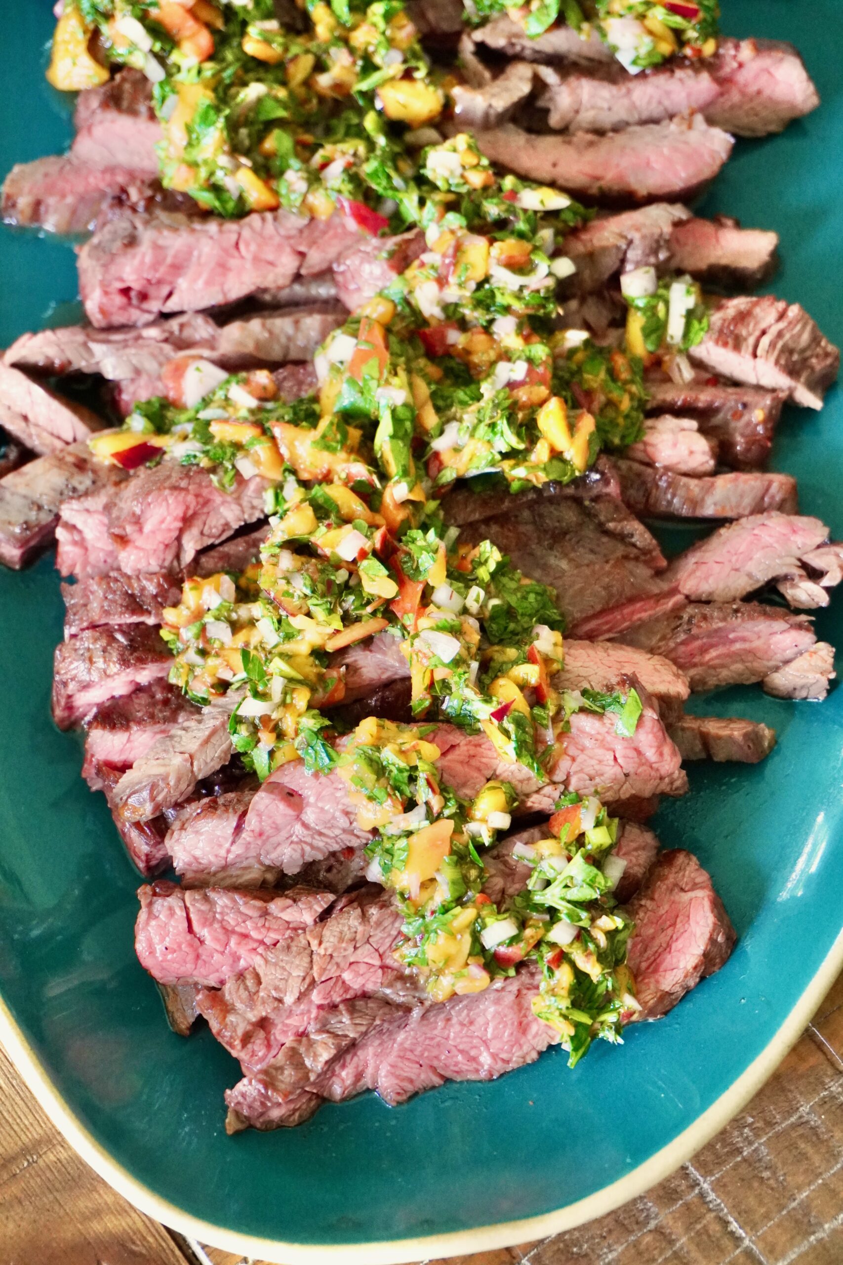 Easy chimichurri recipe for steak served family-style on a platter
