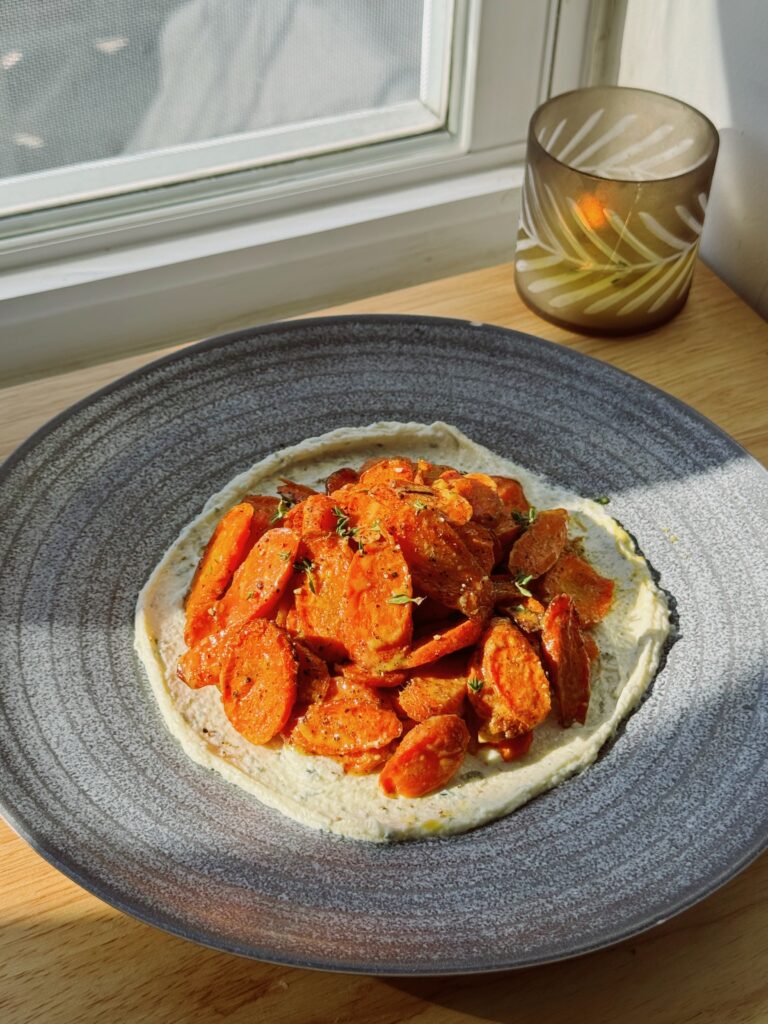 Elegant side dish of roasted carrots over herbed Boursin
