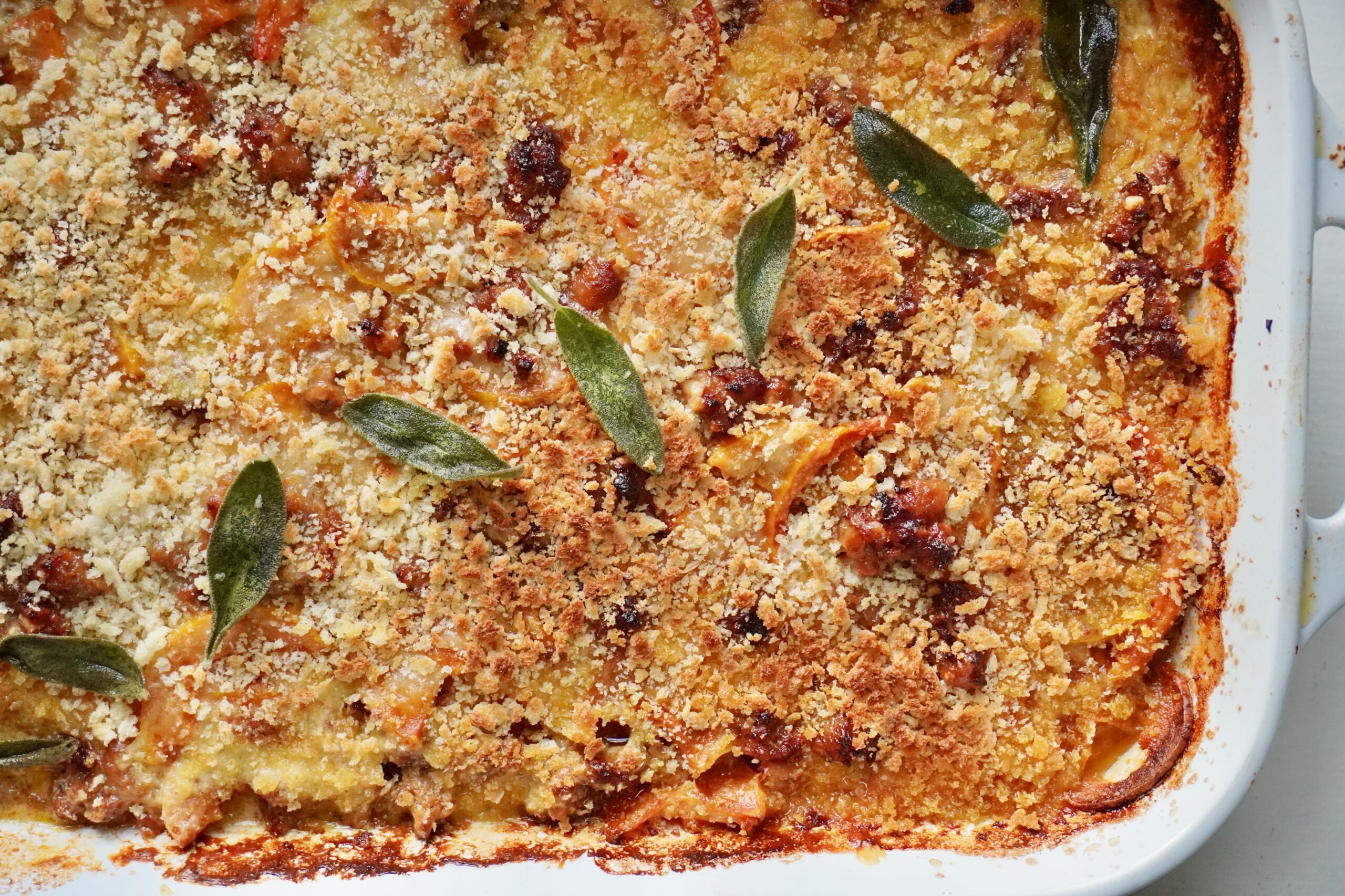 Golden breadcrumb-topped squash gratin in a casserole dish.
