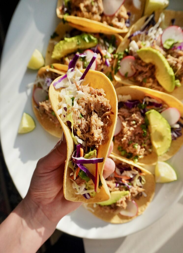Shredded mojo pork tacos in warm tortillas