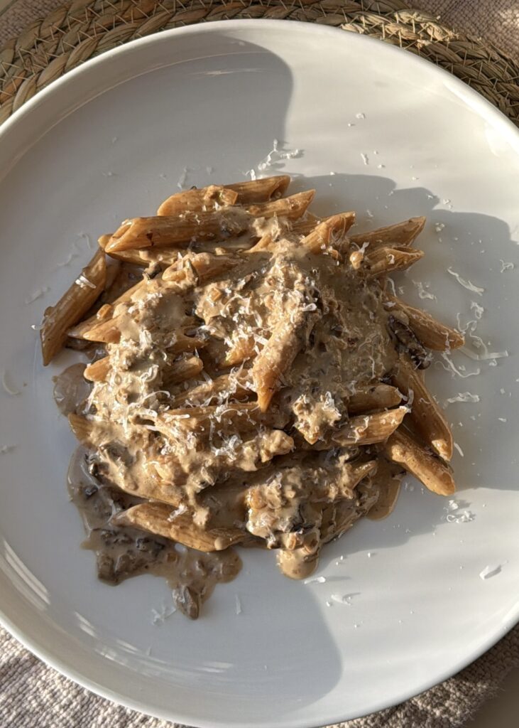 Cozy bowl of penne pasta tossed in rich mushroom cream sauce