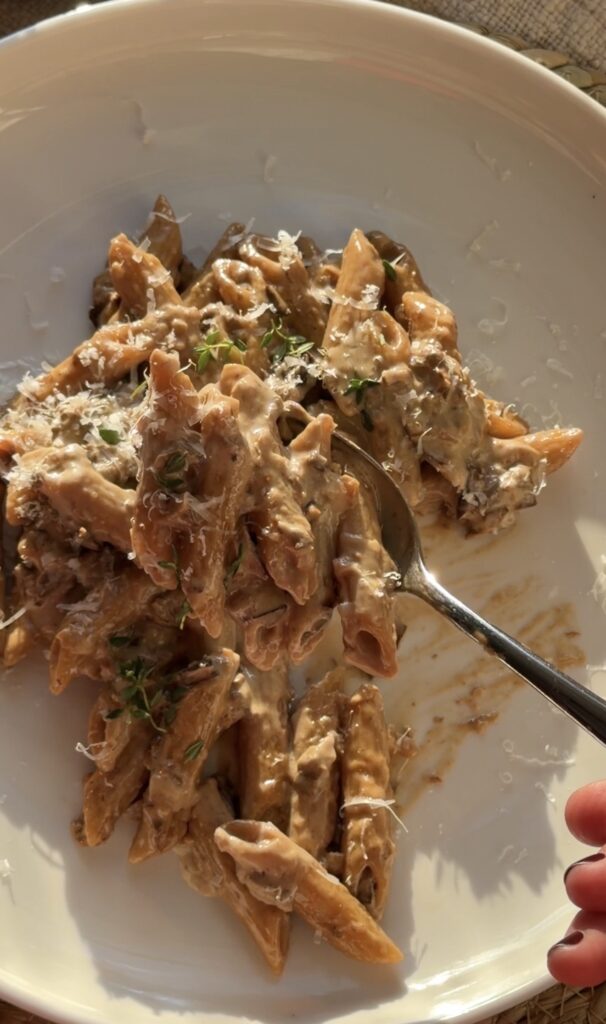 Close-up of creamy porcini penne pasta with Parmesan