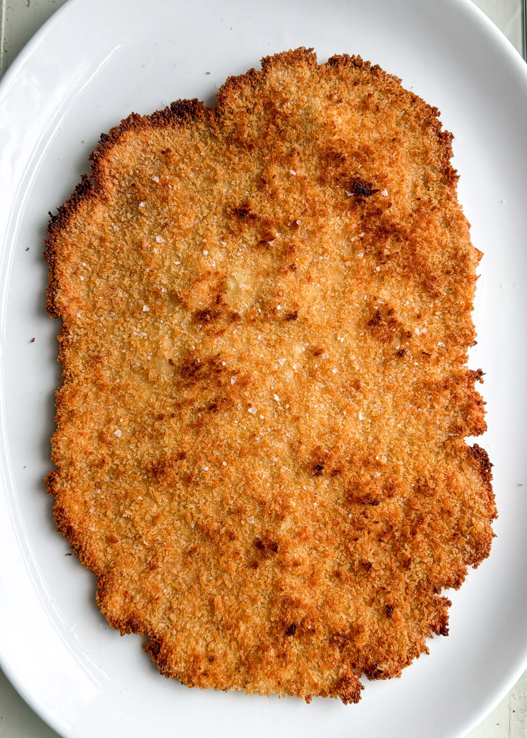Crispy baked chicken cutlet with flaky sea salt