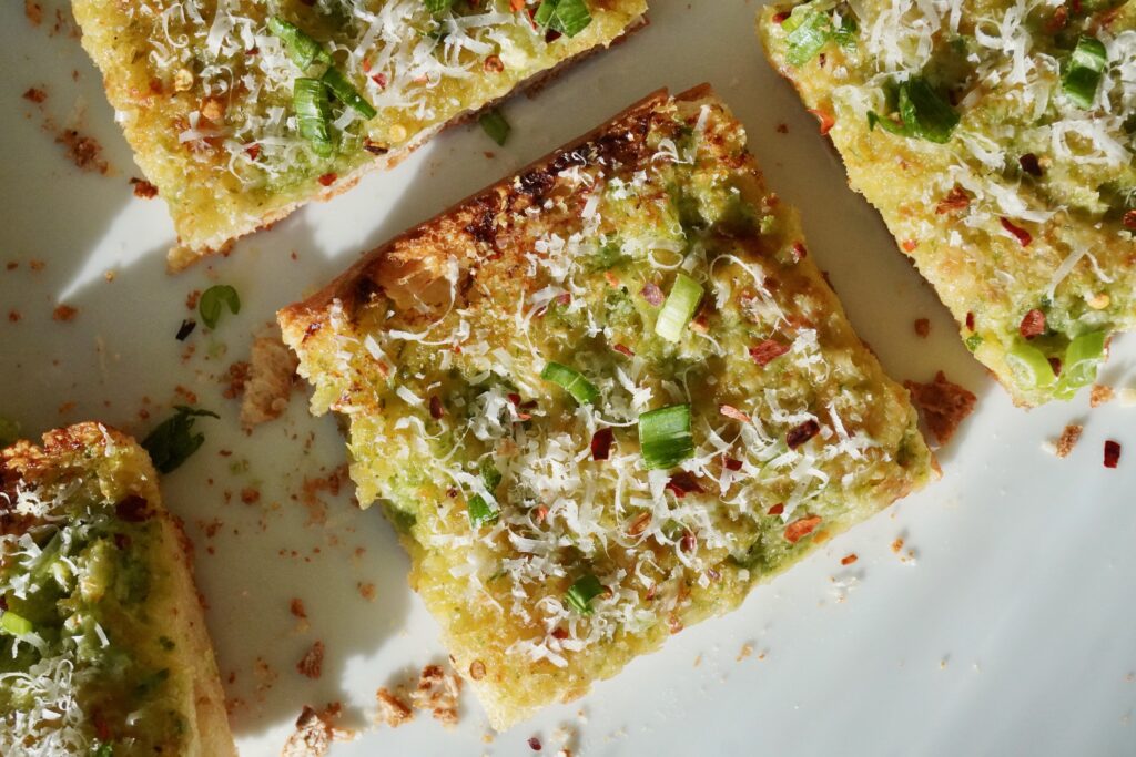 A close-up of the crosshatch cuts in the bread filled with bubbling butter