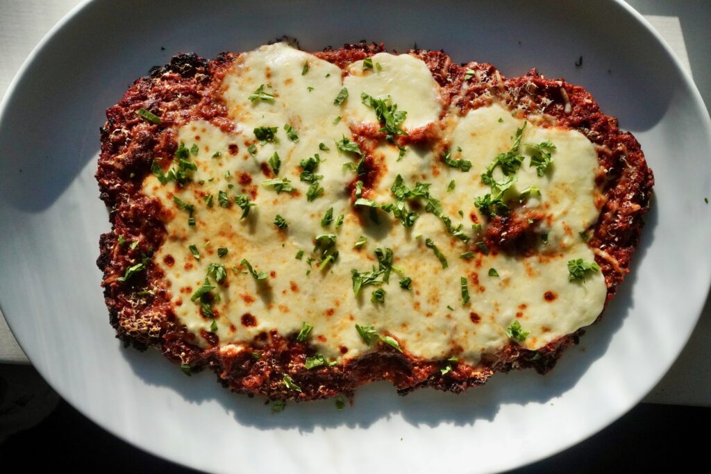 Crispy oven baked chicken parmesan with melted mozzarella and basil