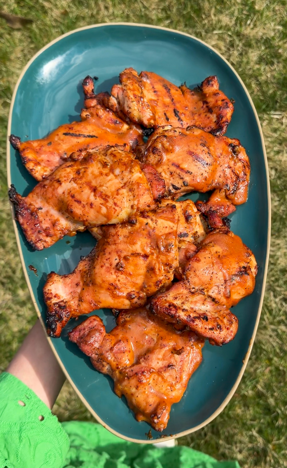 peach bbq chicken on a blue platter