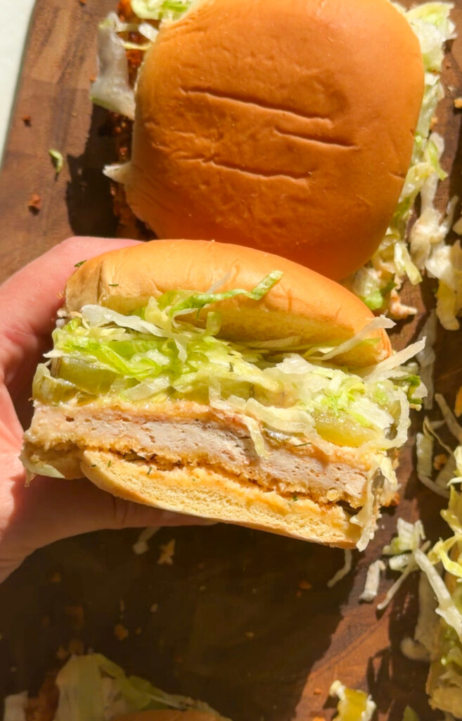 crispy chicken sliders with pickle ranch and shredded lettuce sandwiched in potato buns