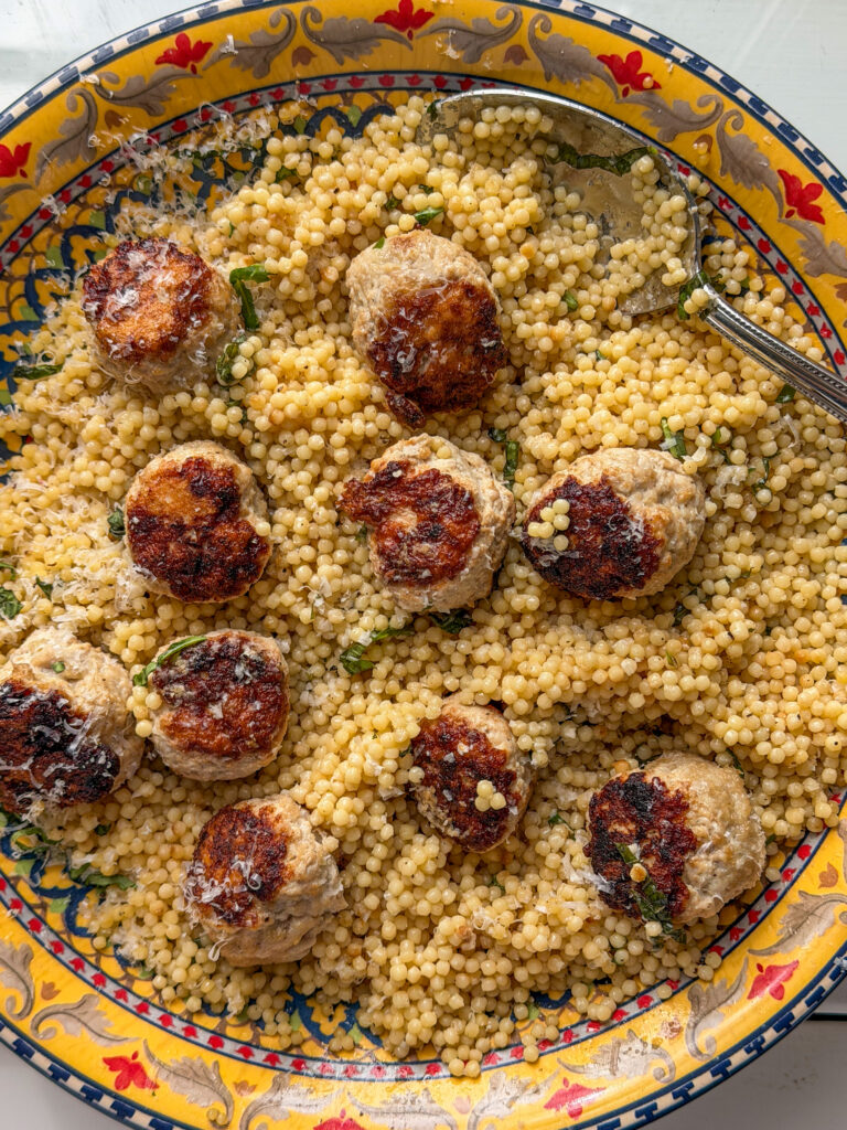 Easy family dinner with balsamic turkey meatballs and one pan pearl couscous served in a large dish