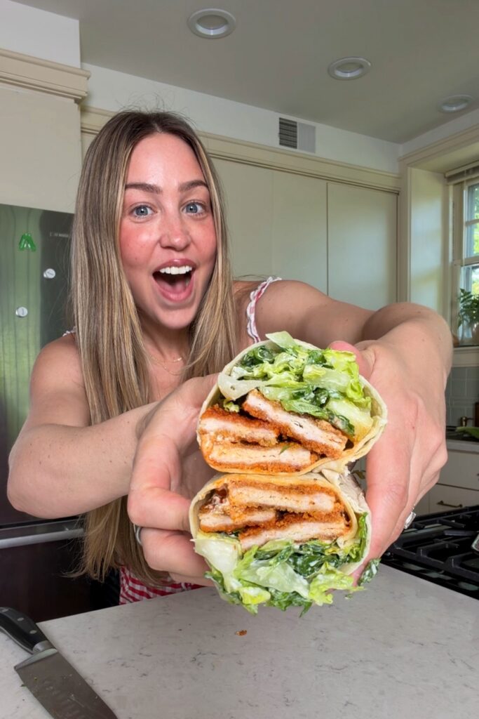 Chef holding Buffalo chicken wrap in 2 hands