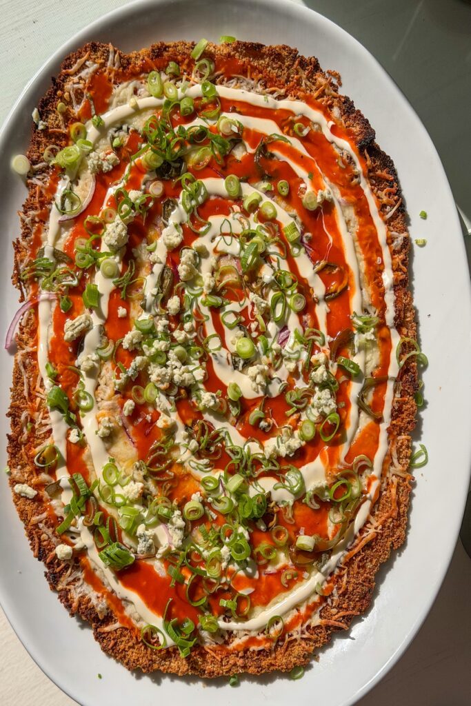 chicken pizza with swirly sauce topping