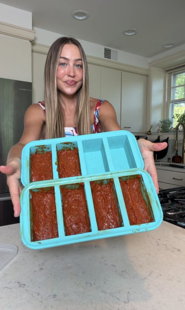 Six spicy vodka sauce concentrate portions divided among turquoise silicone freezer molds
